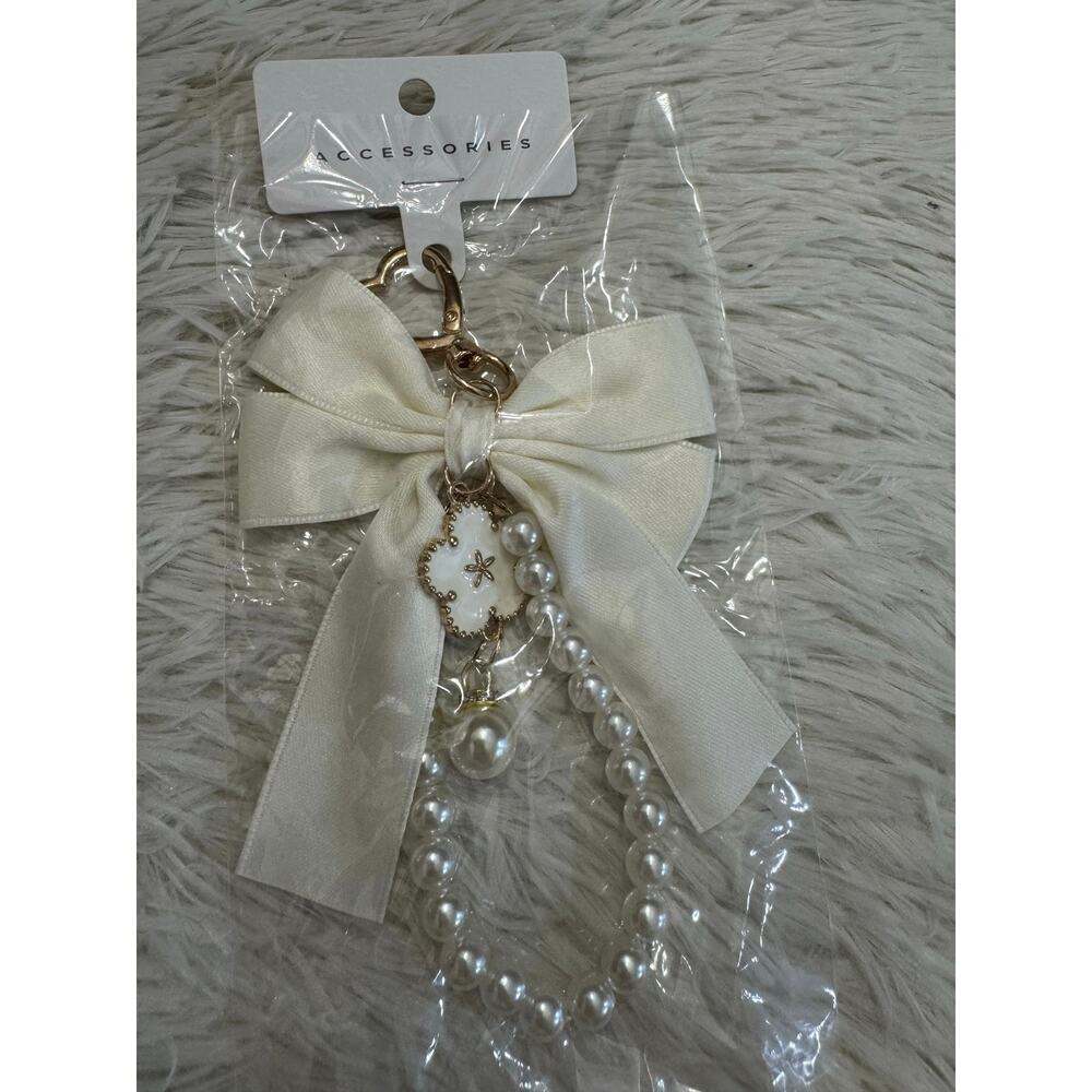 White pearl strap keychain bag charm with gold heart charm flower and bow